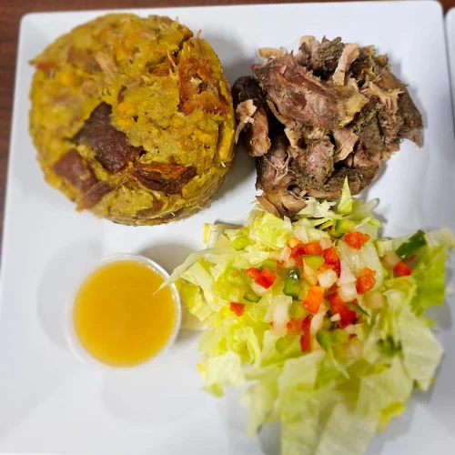 Mofongo con Pernil - Traditional mashed plantains served with our signature slow-roasted pork — a Puerto Rican classic.