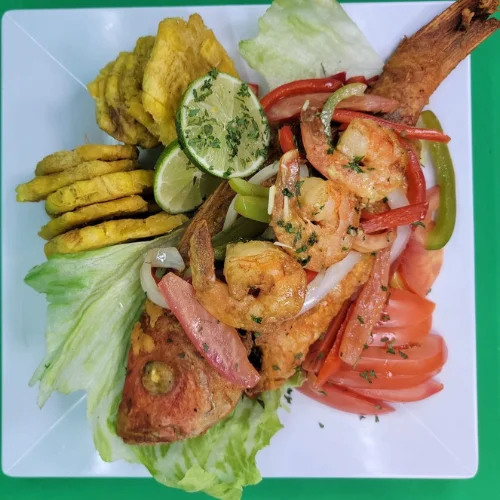 Pescado y Camarones con Tostones - Fresh fish and shrimp served alongside crispy fried plantains.